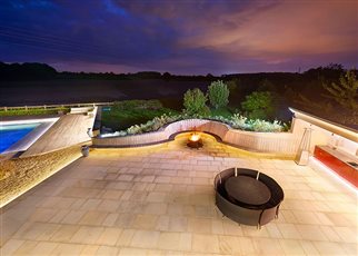 night time view of entertainment area with fire pit