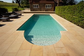 York stone paving surrounds the pool at our BALI winning garden in Shamley Green, Surrey
