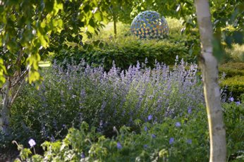 Sculpture viewed through planting in this Suffolk 'country garden'