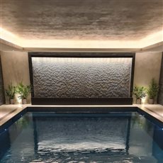 AquaVeil® installed within a private swimming pool area. The AquaVeil® has a component system design, allowing us to send the water feature to Jersey for the pool contractor to install. A striking addition to the pool area.