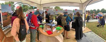 Show goers at RHS Hampton Court 2023 on the ACO stand discussing rainwater solutions with ACO staff.