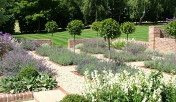 Old Essex Farmhouse garden, with a semi formal layout.  Drifts of textural planting, scented plants and clipped topiary provide a traditional feel to this peaceful country garden.