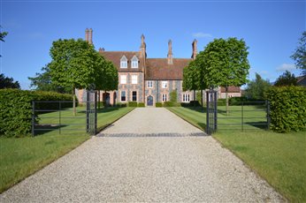 The formal, elegant approach to a house near Bury St Edmunds, Suffolk.  Using Cube pruned Lime trees to frame the drive and balance the grander of the house itself.